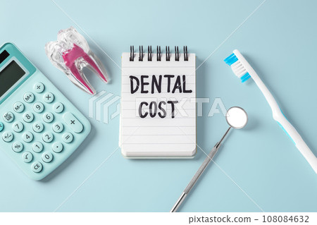 Dental cost concept, dentist tool, tooth with calculator on blue background, top view 108084632