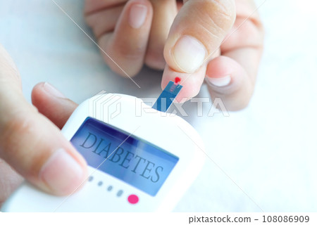hand of people check diabetes and high blood glucose monitor with digital pressure gauge. Healthcare and Medical concept 108086909