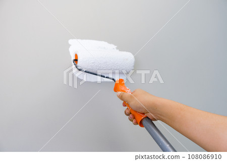 Home repairman paint the walls gray walls, painters use white paint brush rolls.soft focus 108086910