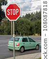Stop sign in front of a crossing with a rides car. 108087818