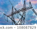 Silhouette of a high voltage tower with the clouds at sunset on a background 108087829