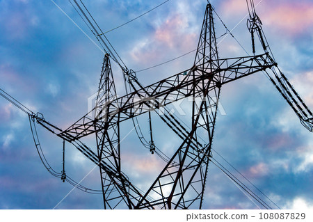 Silhouette of a high voltage tower with the clouds at sunset on a background Silhouette of a high voltage tower with the clouds at sunset on a background 108087829