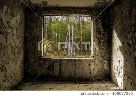 View through the hole for a windows in a damaged abandoned panel house. View through the hole for a windows in a damaged abandoned panel house. 108087830