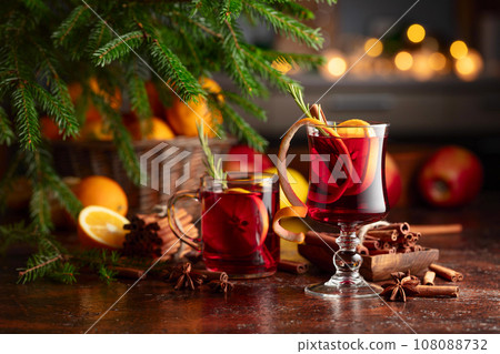 Christmas mulled wine with citrus, apples, cinnamon, anise, and rosemary. 108088732