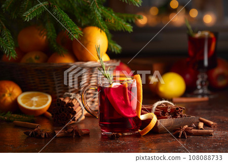 Christmas mulled wine with citrus, cinnamon, anise, and rosemary. 108088733