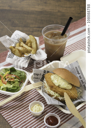 Fish burger, fries and salad, vertical position 108088788