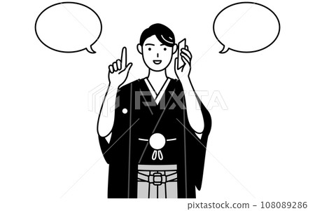 A man wearing a crested hakama pointing while talking on the phone A man wearing a crested hakama pointing while talking on the phone 108089286