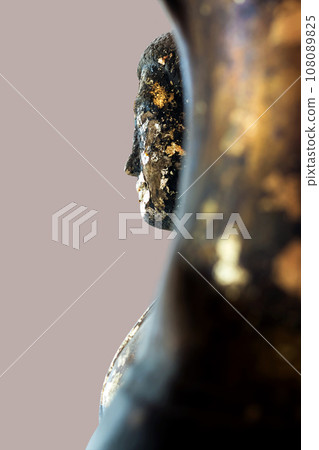 The side face of an ancient Buddha statue, more than 400 years old. The side face of an ancient Buddha statue, more than 400 years old. 108089825