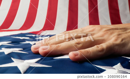 Hand caressing the stars and stripes of a USA flag Hand caressing the stars and stripes of a USA flag 108090164