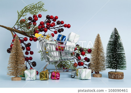 Set with a caddy filled with colorful gifts and holly branch and christmas tree Set with a caddy filled with colorful gifts and holly branch and christmas tree 108090461