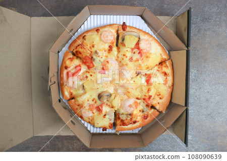 a box of pizza ,shrimp pizza 108090639