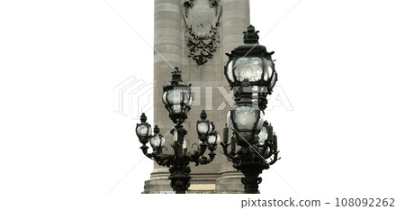 Lamp posts on Alexander III Bridge (carved on white background). Paris, France. This arch bridge is one of the most beautiful river crossings in the world Lamp posts on Alexander III Bridge (carved on white background). Paris, France. This arch bridge is one of the most beautiful river crossings in the world 108092262