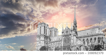 Notre Dame de Paris (against the background of a sky at sunset), also known as Notre Dame Cathedral or simply Notre Dame, is a Gothic, Roman Catholic cathedral of Paris, France 108092370