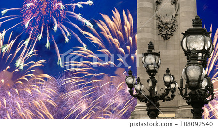Celebratory colorful fireworks over the Lamp posts on Alexander III Bridge. Paris, France. This arch bridge is one of the most beautiful river crossings in the world Celebratory colorful fireworks over the Lamp posts on Alexander III Bridge. Paris, France. This arch bridge is one of the most beautiful river crossings in the world 108092540
