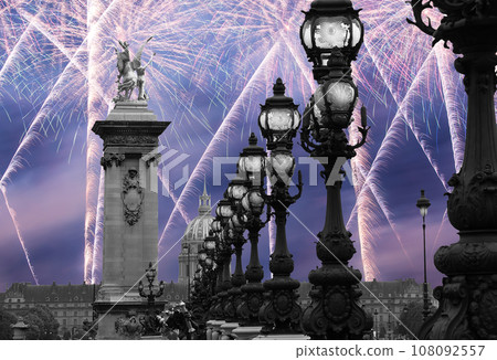 Celebratory colorful fireworks over the Lamp posts on Alexander III Bridge. Paris, France. This arch bridge is one of the most beautiful river crossings in the world Celebratory colorful fireworks over the Lamp posts on Alexander III Bridge. Paris, France. This arch bridge is one of the most beautiful river crossings in the world 108092557