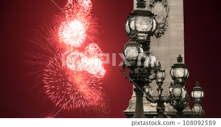 Celebratory colorful fireworks over the Lamp posts on Alexander III Bridge. Paris, France. This arch bridge is one of the most beautiful river crossings in the world Celebratory colorful fireworks over the Lamp posts on Alexander III Bridge. Paris, France. This arch bridge is one of the most beautiful river crossings in the world 108092589