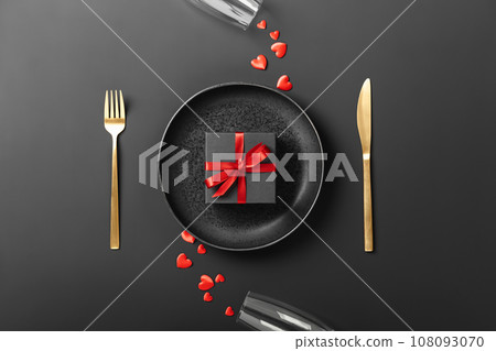 Beautiful romantic table setting on dark background top view Beautiful romantic table setting on dark background top view 108093070
