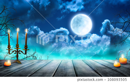 Smoke and mist on old wooden table with candles, defocused Halloween backdrop. Smoke and mist on old wooden table with candles, defocused Halloween backdrop. 108093505