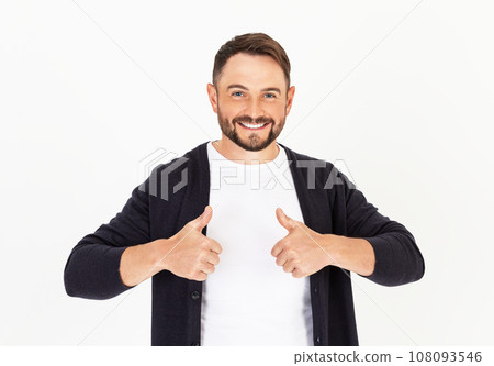 Young handsome man with beard wearing casual clothes on a white background, approving doing positive gesture with hand, thumbs up. Young handsome man with beard wearing casual clothes on a white background, approving doing positive gesture with hand, thumbs up. 108093546