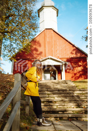 Hiking in autumn forest. Tourist walks through autumn park in sunny weather. Adventure concept. 108093678