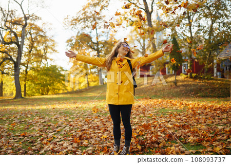 Hiking in autumn forest. Tourist walks through autumn park in sunny weather. Adventure concept. 108093737