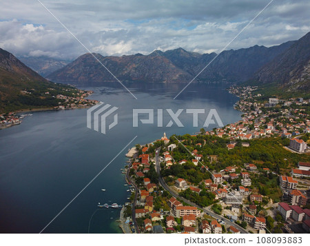 Aerial drone high view of Kotor bay, Boka Kotorska and coastal town Kotor, Cattaro, in Montenegro. Location place famous resort Montenegro. Adriatic fjord surrounded by rugged mountains Aerial drone high view of Kotor bay, Boka Kotorska and coastal town Kotor, Cattaro, in Montenegro. Location place famous resort Montenegro. Adriatic fjord surrounded by rugged mountains 108093883