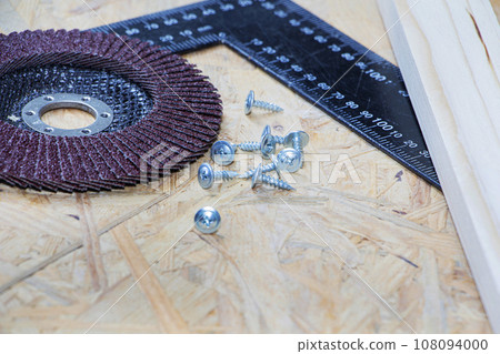 tools for repair and construction. Screwdriver, furniture screws, measuring tape, self-tapping screws, with a place for text. Top view tools for repair and construction. Screwdriver, furniture screws, measuring tape, self-tapping screws, with a place for text. Top view 108094000