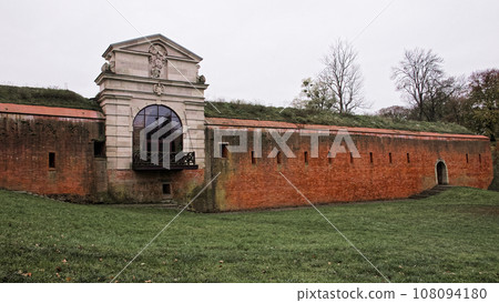 Old Lublin gate (Brama Lubelska) of fortress in Zamosc, Poland. Ancient fortification brick wall. 108094180