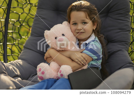portrait of a little girl hugging a teddy bear portrait of a little girl hugging a teddy bear 108094279