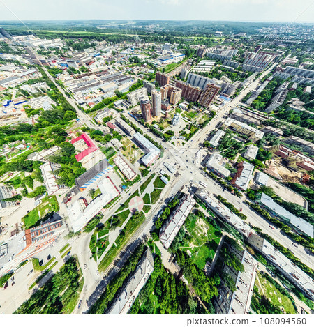 Aerial city view with crossroads and roads, houses, buildings, parks and parking lots. Sunny summer panoramic image Aerial city view with crossroads and roads, houses, buildings, parks and parking lots. Sunny summer panoramic image 108094560