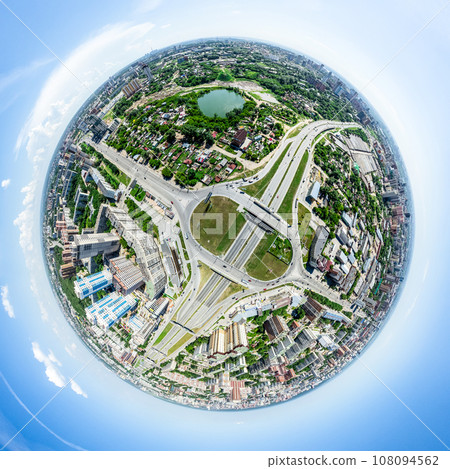 Aerial city view with crossroads and roads, houses, buildings, parks and parking lots. Sunny summer panoramic image 108094562