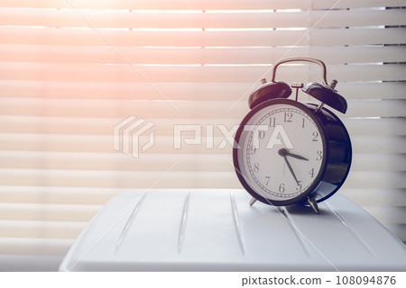 Close up alarm clock at the window area 108094876