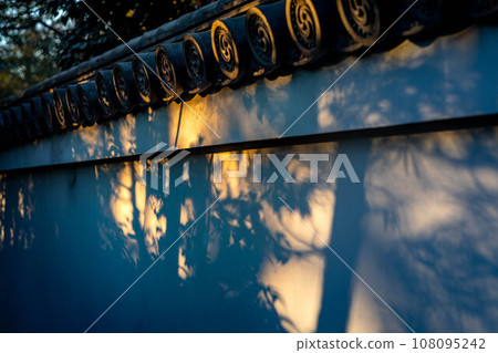 Autumn at Myoshin-ji Temple and Taizo-in, autumn image of the setting sun shining on the white wall of Tsukiji wall leading to Mizuko Jizo, autumn tree shadows Autumn at Myoshin-ji Temple and Taizo-in, autumn image of the setting sun shining on the white wall of Tsukiji wall leading to Mizuko Jizo, autumn tree shadows 108095242