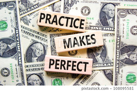 Practice makes perfect symbol. Concept words Practice makes perfect on wooden block. Dollar bills. Beautiful background from dollar bills. Business practice makes perfect concept. Copy space. 108095581