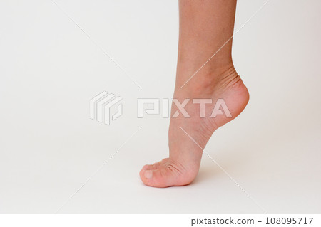 Cropped child leg with lifted heel  108095717