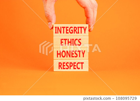 Integrity ethics honesty respect symbol. Concept word Integrity Ethics Honesty Respect on block. Beautiful orange background. Businessman hand. Business integrity ethics honesty respect concept. 108095729