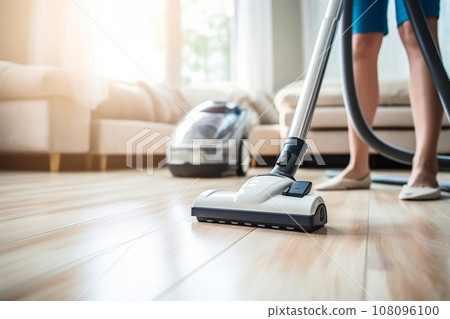 Woman using vacuum cleaner in a bright cozy room at home. Generative AI 108096100