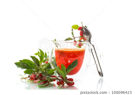Prepared hot drink from ripe goji berries in a glass cup 108096423