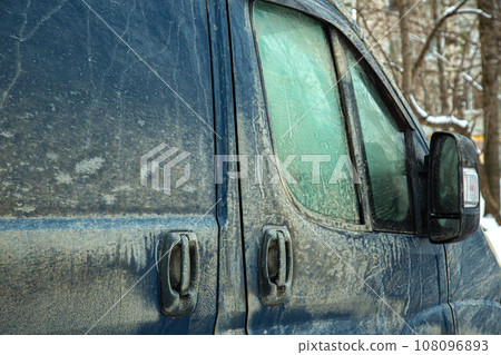 side doors of a cargo minibus with handles and a window covered with a layer of dried dirt and dust, a rear-view mirror with a turn signal is dirty. side doors of a cargo minibus with handles and a window covered with a layer of dried dirt and dust, a rear-view mirror with a turn signal is dirty. 108096893