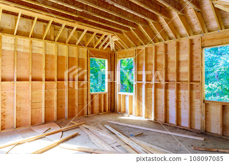 Construction underway interior view of new unfinished house with wooden beams Construction underway interior view of new unfinished house with wooden beams 108097085