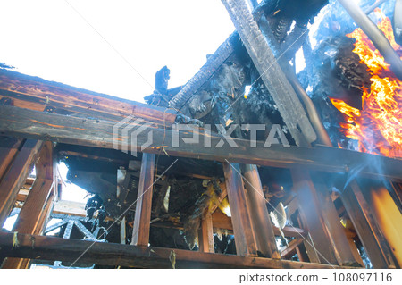 Burning house fully engulfed structure completely destroyed by fire. 108097116