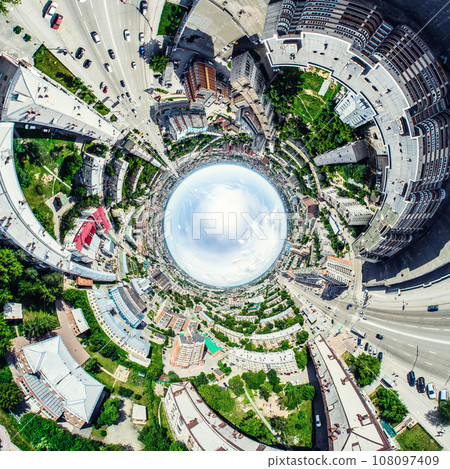 Aerial city view with crossroads and roads, houses, buildings, parks and parking lots. Sunny summer panoramic image Aerial city view with crossroads and roads, houses, buildings, parks and parking lots. Sunny summer panoramic image 108097409