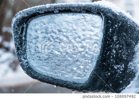 car covered with ice after snowstorm car covered with ice after snowstorm 108097492