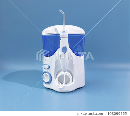 Water Flosser, Dental Oral Irrigator On Blue Background. Dental Equipment Care. Irrigator For Mouth. Cleaning Teeth With Water Jet Under Pressures. Horizontal Plane. 108099565