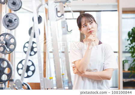 Woman thinking at the gym Woman thinking at the gym 108100844