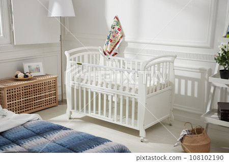 cozy bedroom with baby bed and lamp 108102190