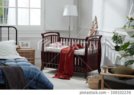 cozy bedroom with baby bed and lamp 108102239