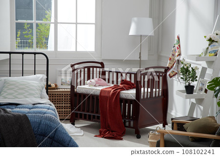 cozy bedroom with baby bed and lamp 108102241