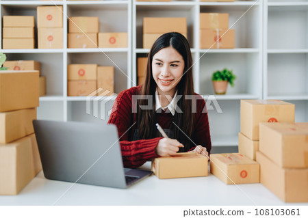 Asian female business owner handles delivery of orders to customers. Asian female business owner handles delivery of orders to customers. 108103061
