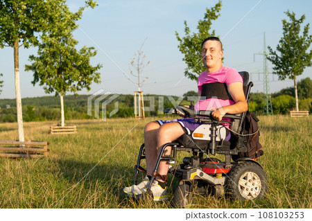 Portrait of disabled man in electric wheelchair in the park.  108103253